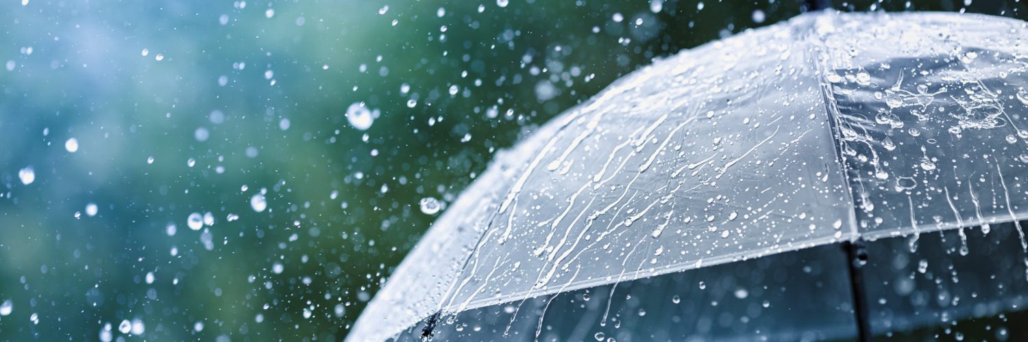 Transparent umbrella under rain against water drops splash backg Transparent umbrella under rain against water drops splash background. Rainy weather concept.